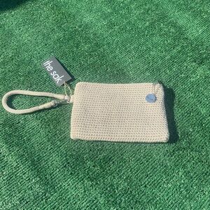 The Sak, wristlet. New. Cream color.